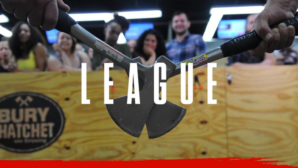 leagueHeader Bury The Hatchet Axe Throwing League Page Header Image. Two axes touching together with axe throwing competitors in background